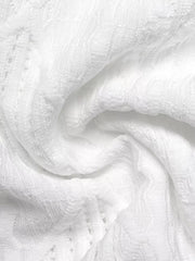 White textured knit maternity t-shirt with openwork detail and bow accent.
