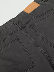 Grey relaxed fit cargo pants with utility pockets and a tan leather patch.