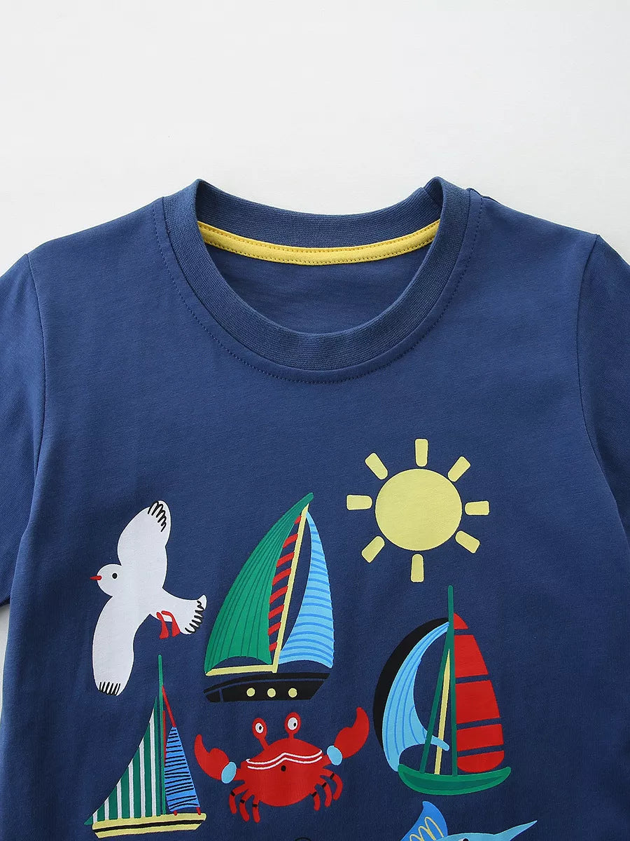 Blue cotton t-shirt with playful sailboats, crab, seagull, and sun graphic.