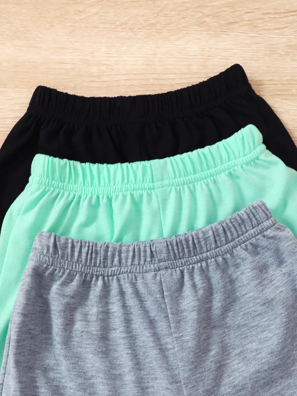 Boys' underwear set in black, mint green, and grey with elastic waistbands.