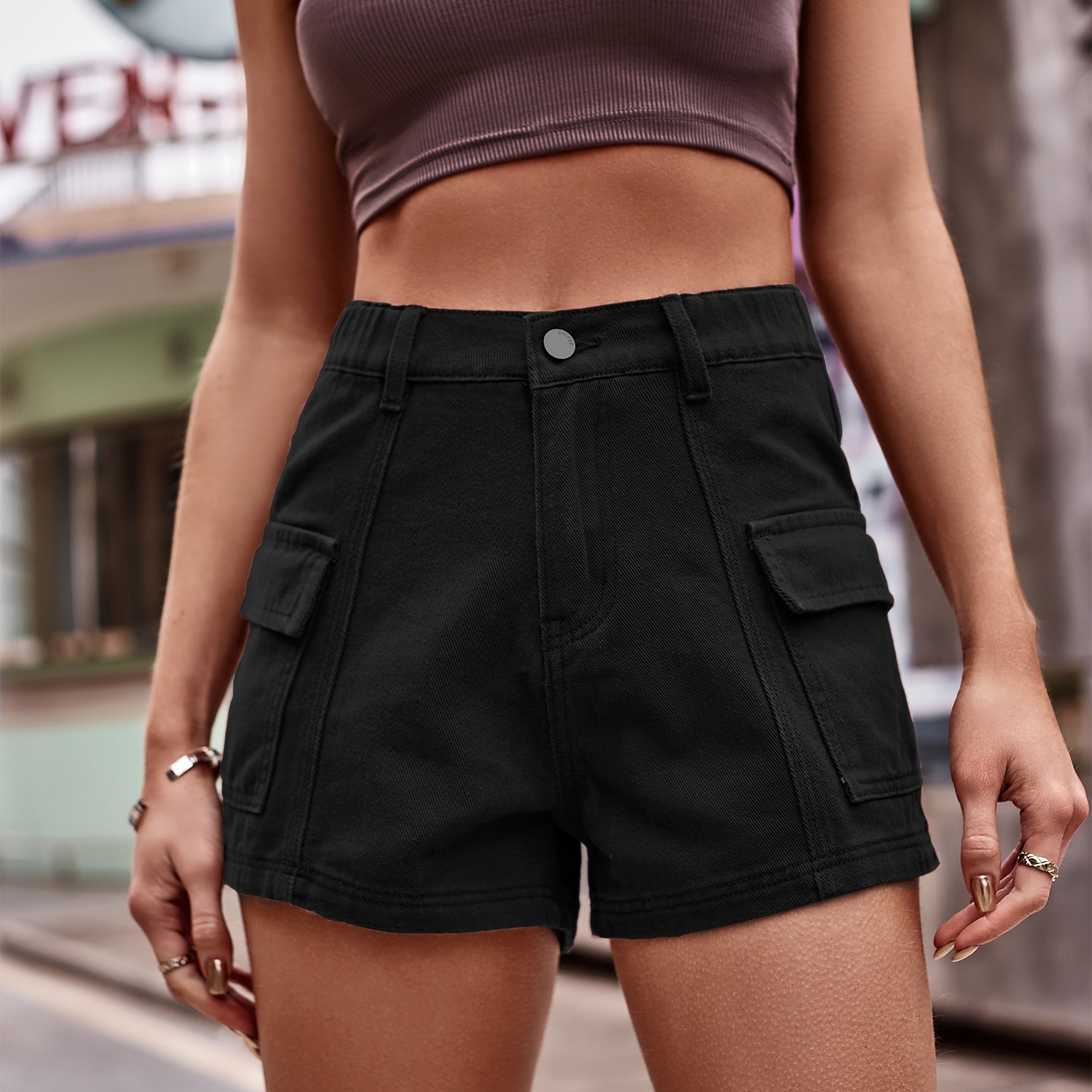 Black denim utility shorts with high-rise waist and cargo pockets.