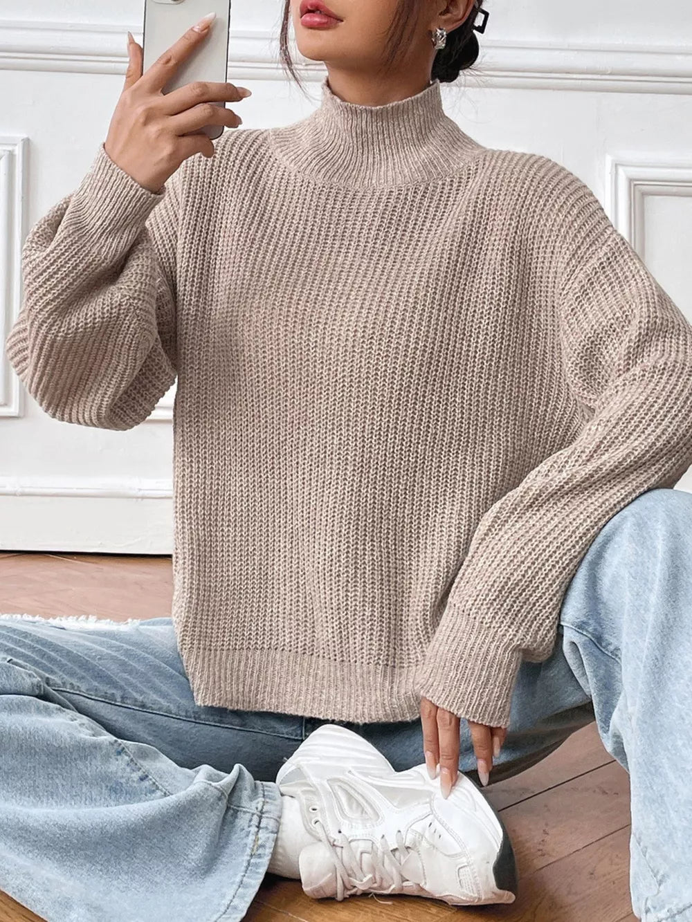Relaxed fit ribbed knit turtleneck sweater in beige acrylic with balloon sleeves.