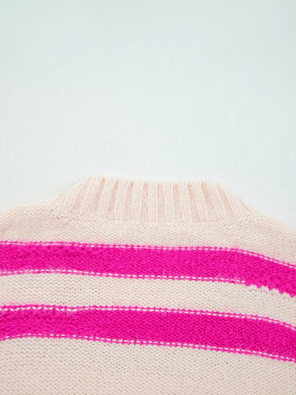 Cream and hot pink striped acrylic crew neck sweater with fuzzy texture.