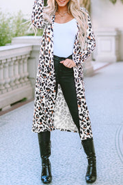 Leopard print duster cardigan with long sleeves and open front, styled with a white tank and black pants.