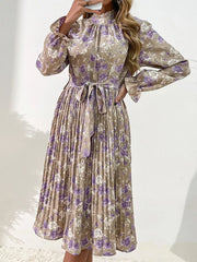 Elegant floral midi dress in khaki with purple roses, featuring a tie waist and pleated skirt.