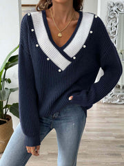 Dark blue ribbed knit V-neck sweater with white stripe detail and pearl buttons.