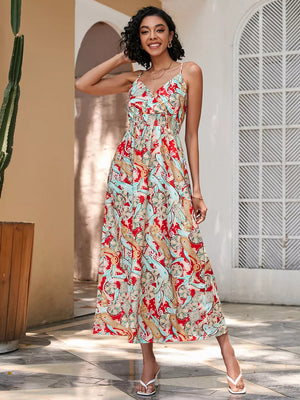 Chic floral midi dress with spaghetti straps and smocked waist in red, blue, and tan paisley print.