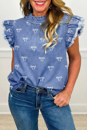 Denim blouse with ruffled neckline and bow print, featuring frayed short sleeves.