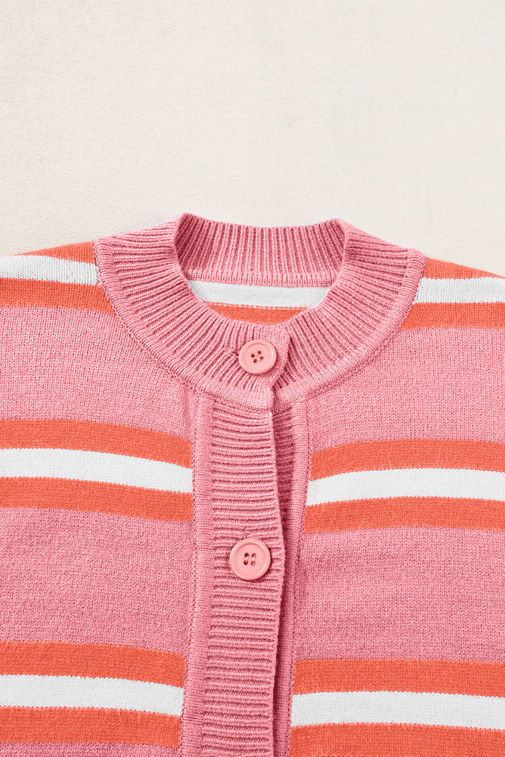 Pink striped knit cardigan with button front and crew neck.