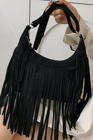 Black suede crescent crossbody bag with long fringe detail and silver hardware.