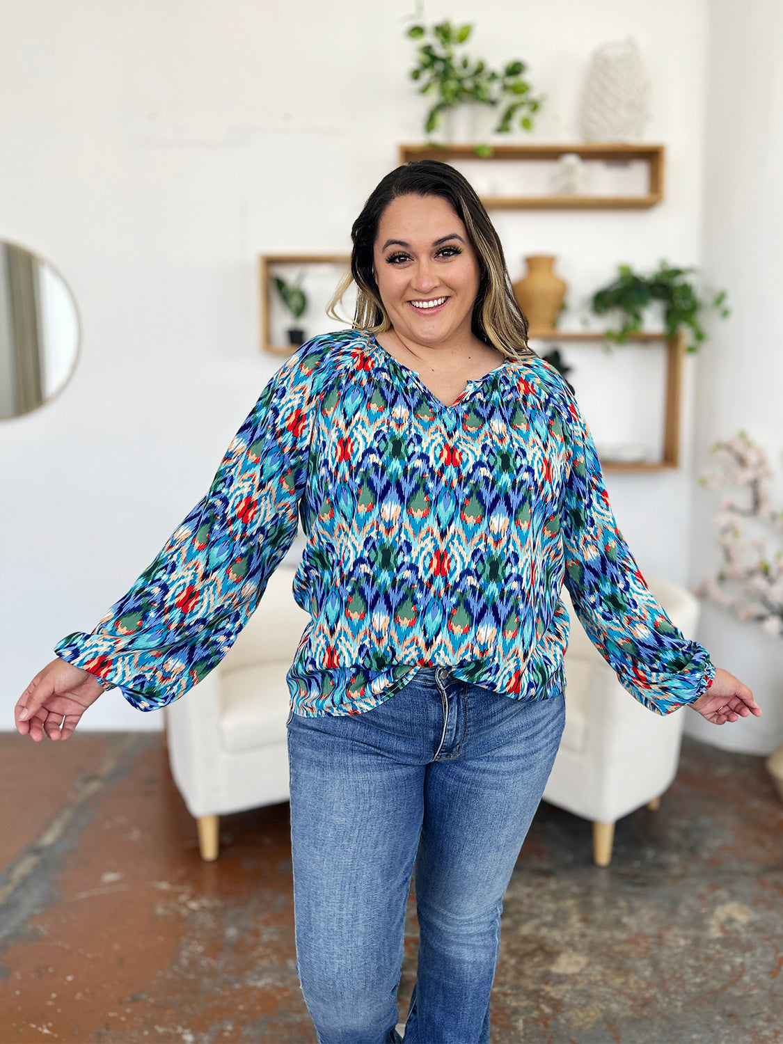 Prismatic ikat blouse in blue with voluminous sleeves and a v-neck.
