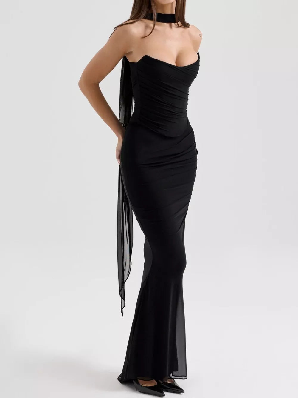 Black sweetheart tube top dress with ruched bodice and flowing maxi skirt.