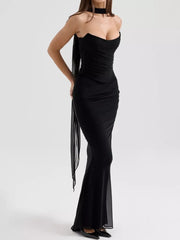 Black sweetheart tube top dress with ruched bodice and flowing maxi skirt.