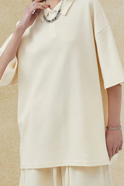 Boxy textured polo shirt in ivory with a relaxed fit and short sleeves.