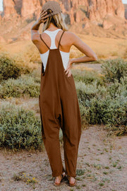 Coffee brown cotton jumpsuit with wide legs and pockets, worn with a white tank top.