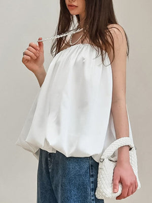 White strapless bubble hem blouse with a gathered neckline.