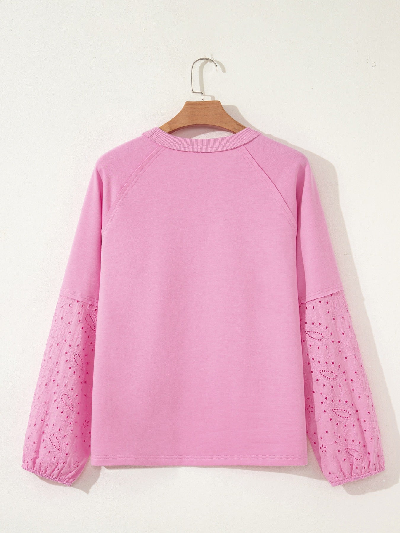 Pink crew-neck sweatshirt with embroidered eyelet sleeves
