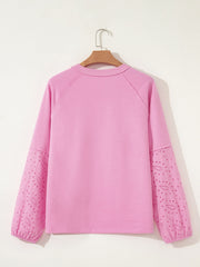 Pink crew-neck sweatshirt with embroidered eyelet sleeves