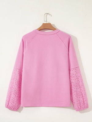Pink crew-neck sweatshirt with embroidered eyelet sleeves