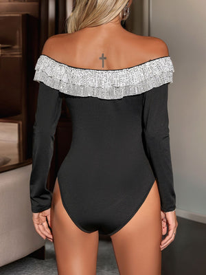 Black long sleeve bodysuit with sequin-trimmed off-the-shoulder neckline