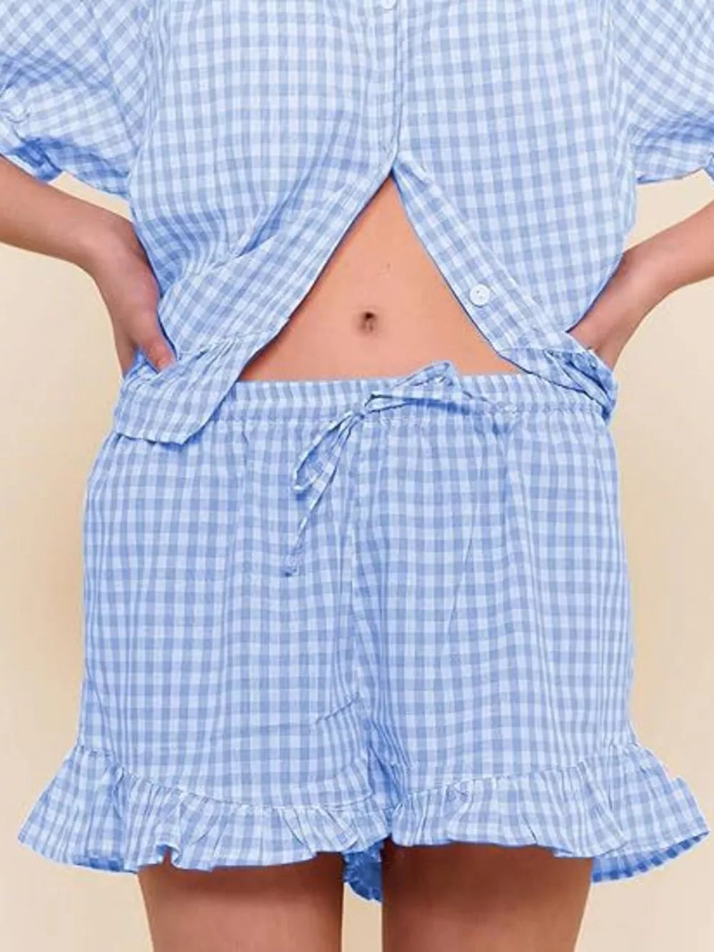 Blue gingham two-piece set with button-front top and ruffle-trim shorts.