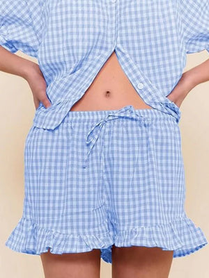 Blue gingham two-piece set with button-front top and ruffle-trim shorts.