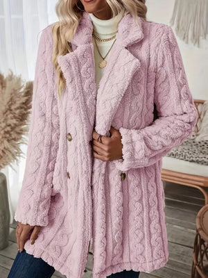 Pink faux shearling double-breasted coat with cable knit texture and button closure.