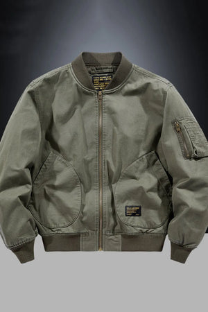 Army green bomber jacket with patch detail, zippered pockets, and ribbed cuffs.