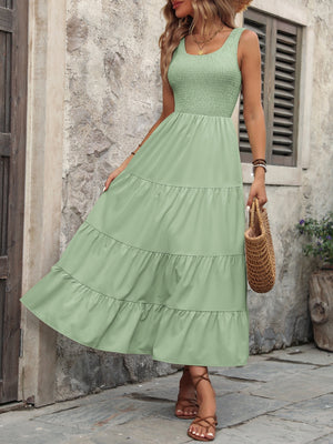 Light green smocked bodice tiered maxi dress with a scoop neck and sleeveless design.