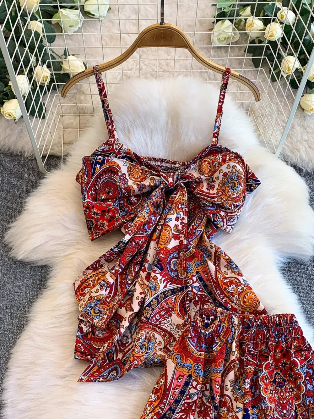 Chic cami and wide-leg pant set in colorful paisley print with a knotted front cami.