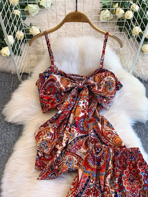 Chic cami and wide-leg pant set in colorful paisley print with a knotted front cami.