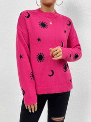 Hot pink knit sweater with black cosmic sun, moon, and star print, drop shoulder, crew neck.