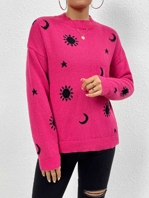 Hot pink knit sweater with black cosmic sun, moon, and star print, drop shoulder, crew neck.