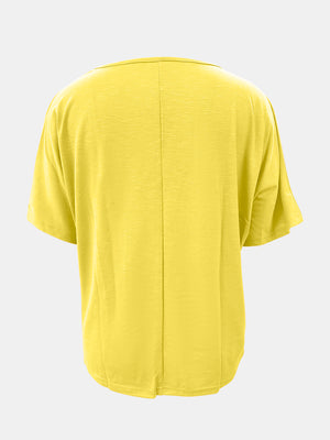 Canary yellow relaxed fit dolman sleeve tee with V-neck and textured fabric.
