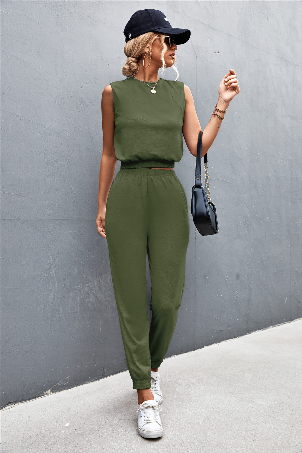 Army green cropped muscle tank and jogger set with padded shoulders and elastic waistband.