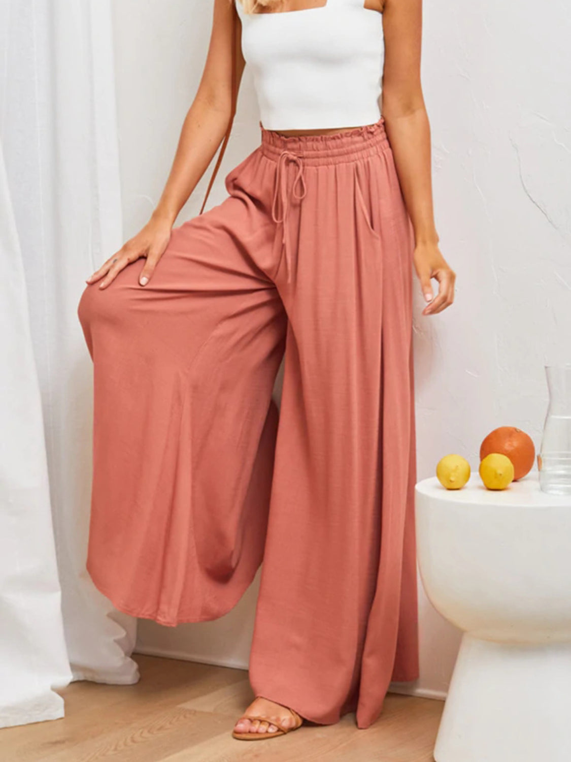 Coral gathered waist wide-leg palazzo maternity pants with drawstring and pockets.
