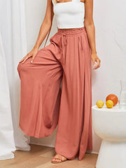 Coral gathered waist wide-leg palazzo maternity pants with drawstring and pockets.