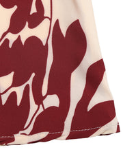 Maxi dress with a bold floral print in burgundy and cream, featuring a deep V-neck.