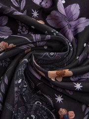 Black mesh midi skirt with a whimsical floral and butterfly print in purple and orange.