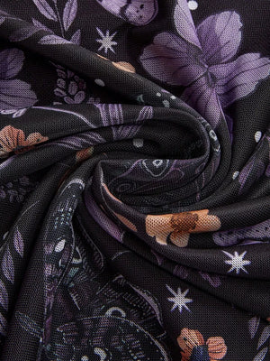 Black mesh midi skirt with a whimsical floral and butterfly print in purple and orange.