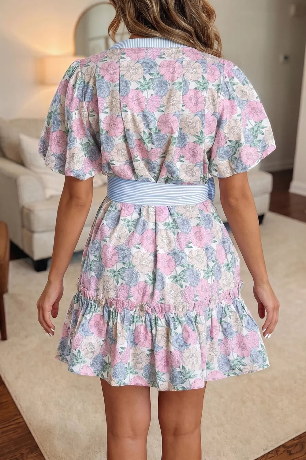 Floral mini dress with contrast trim, belted waist, puff sleeves, and ruffled hem.