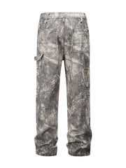 Distressed camo carpenter jeans in gray with multiple pockets and a relaxed fit.