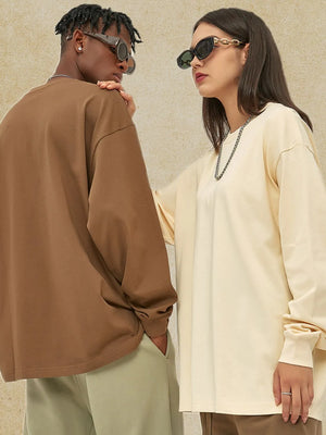 Oversized drop-shoulder crewneck pullover in brown and cream, 100% cotton, long sleeve.