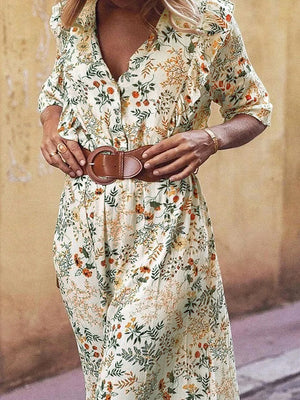 Floral wrap midi dress with ruffled shoulders and a brown belt.