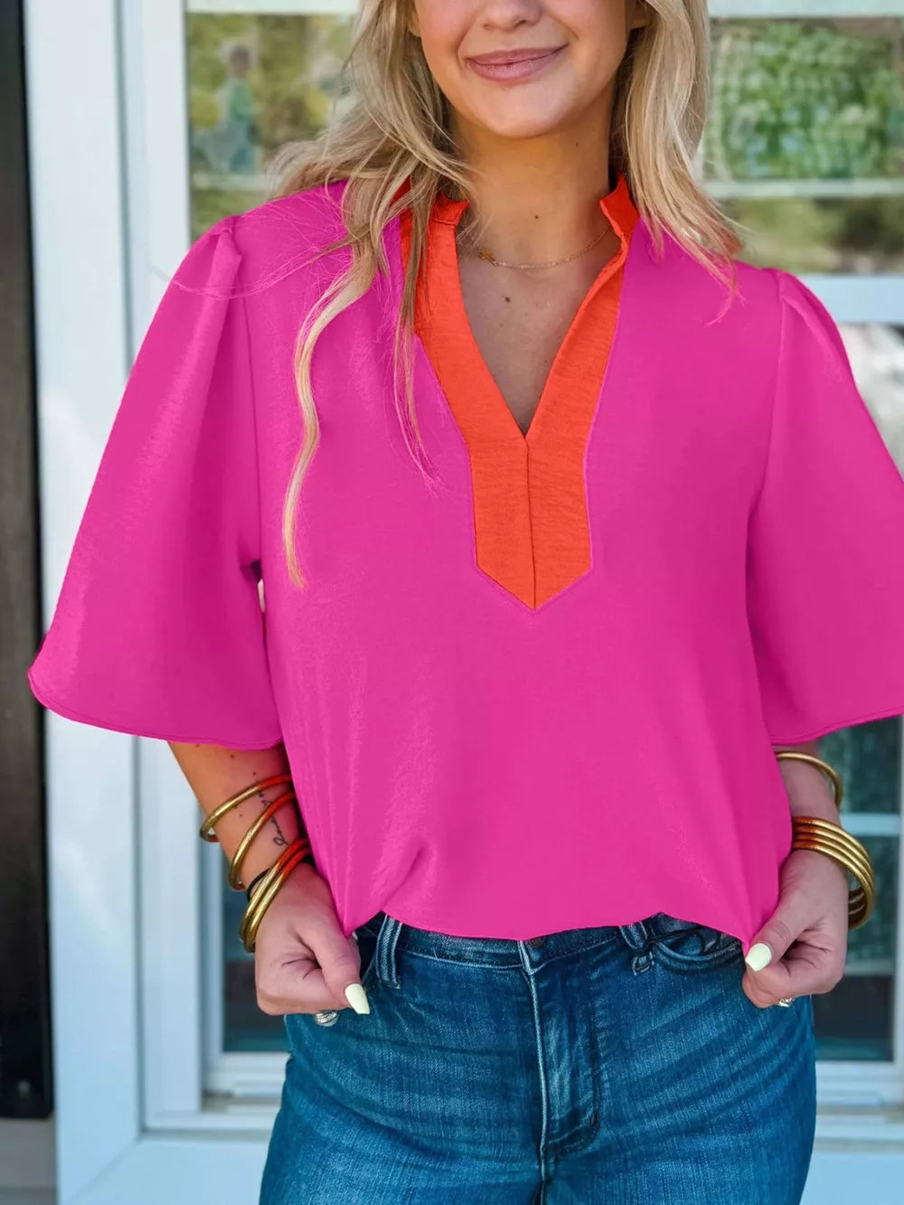 Textured pink blouse with orange V-neck detail and half sleeves