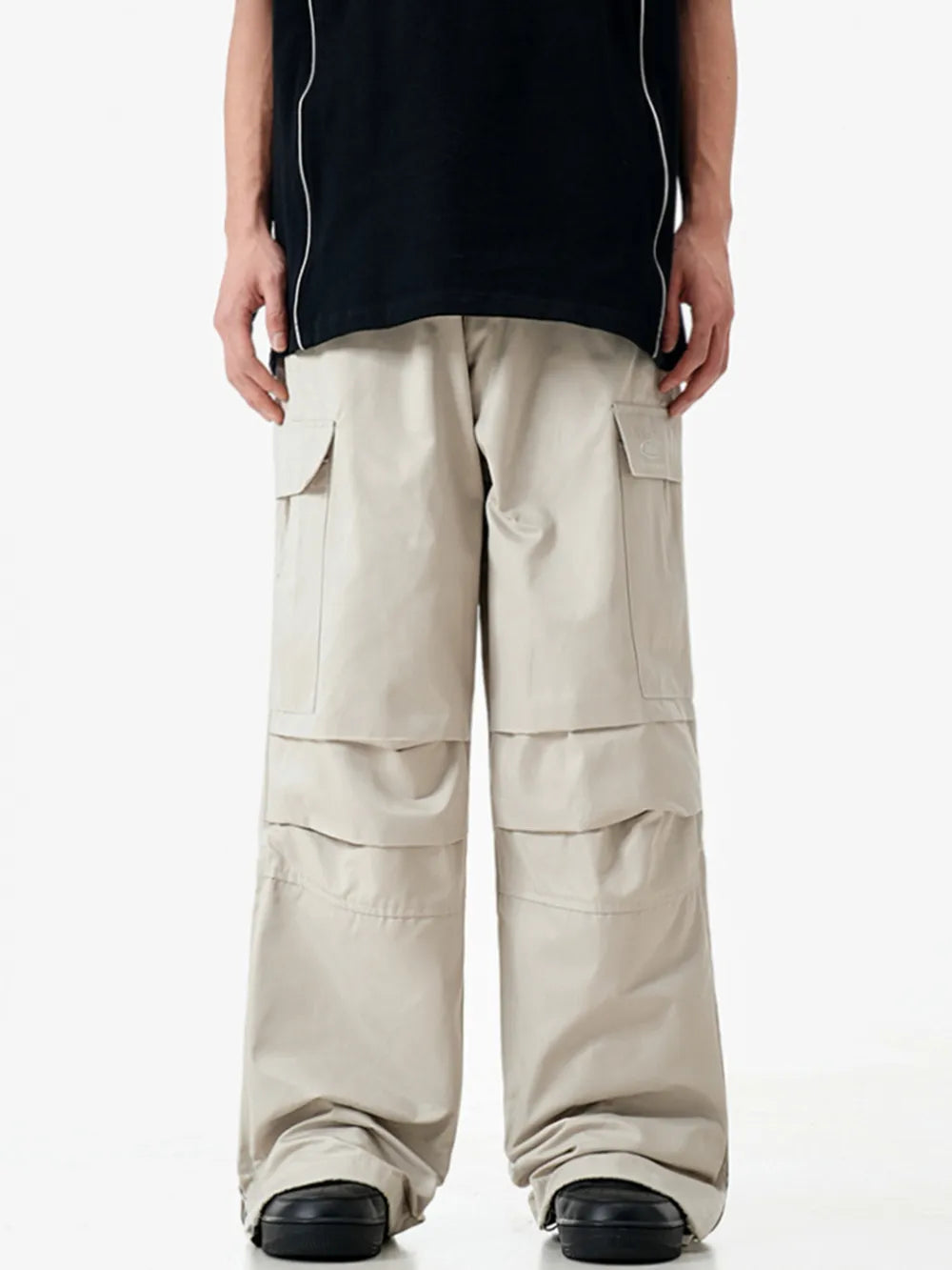 Apricot cargo sweatpants with multiple pockets and layered detailing.