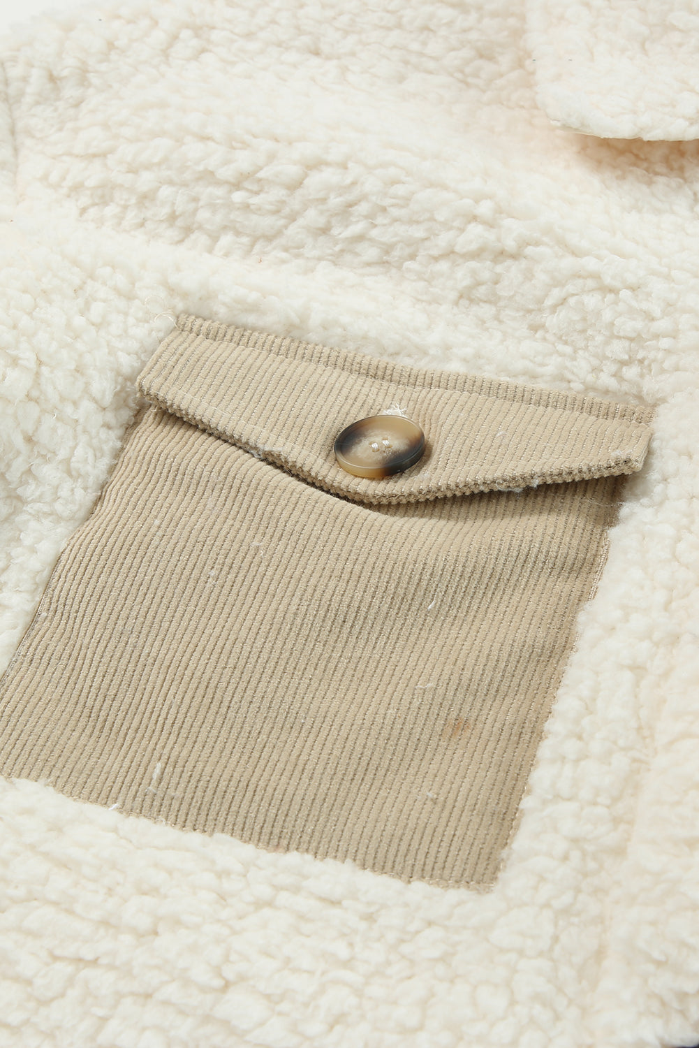 Sherpa coat in beige with corduroy patch pocket and button detail.