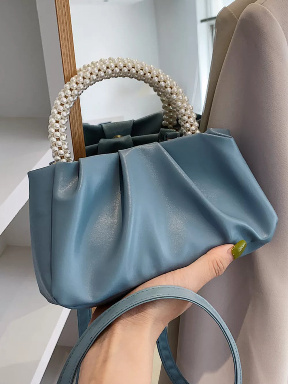 Blue ruched crossbody bag with pearl handle and shoulder strap