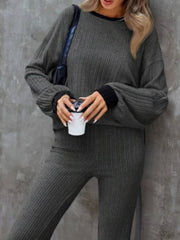 Gray ribbed knit loungewear set with crew neck sweater and bootcut pants.