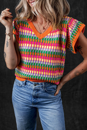 Geometric knit v-neck top in multicolor with flutter sleeves and orange trim.